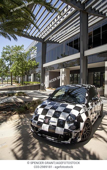 The Vans Shoe Company corporate headquarters facade in Costa Mesa, CA, is decorated with a Fiat car in the company's distinctive checkerboard pattern