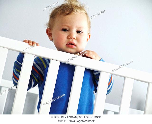 Child standing in a crib
