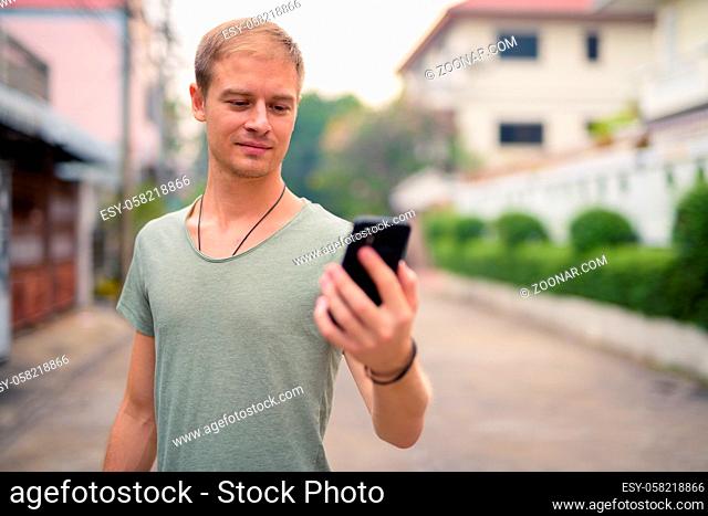 Portrait of handsome tourist man in the streets outdoors