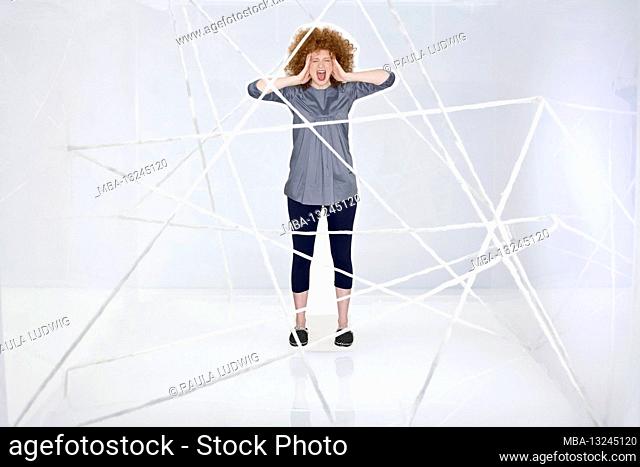 cut-out figure, woman, curly hair, red-haired, leggings, black, blouse, blue, screaming, holding head, net, cobweb-like, white background, slippers, wool