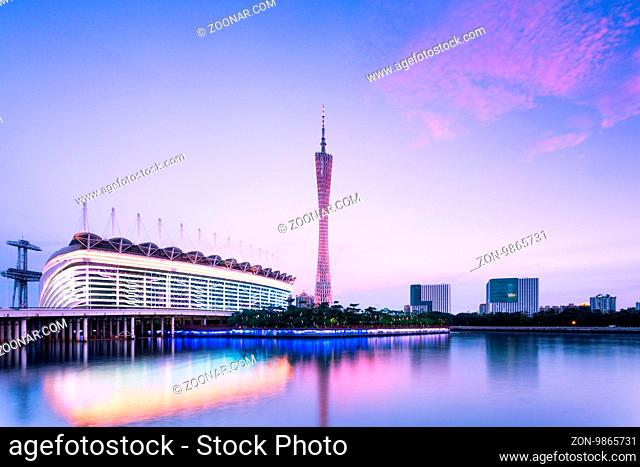 modern buildings and guangzhou tower near river in guangzhou at twilight