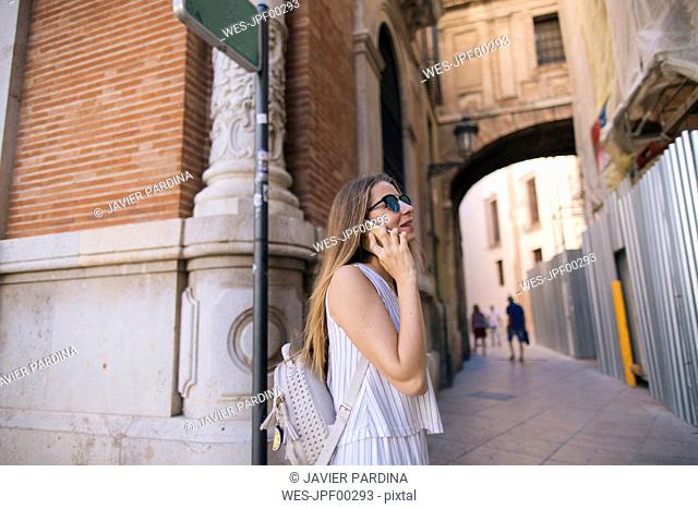 Spain, Valencia, woman on the phone on the city