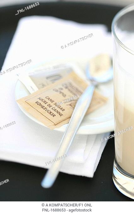 Close-up of sugar packet and cafe macchiato