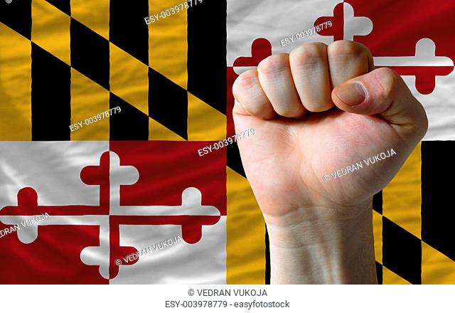 us state flag of maryland with hard fist in front of it symboliz