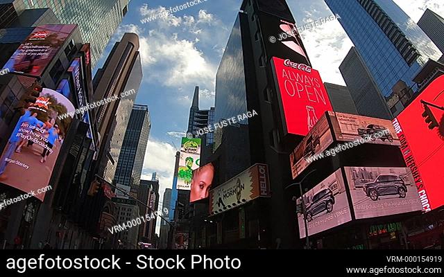 Bright neon signage flashes and buildings in Times Square
