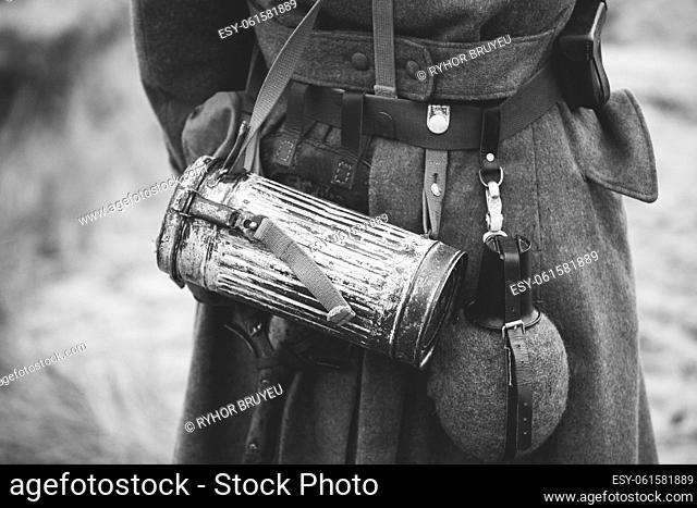 Re-enactor Dressed As German Wehrmacht Infantry Soldier In World War Ii On Marsch. View From Back. German Military Dress Of A German Soldier At World War II