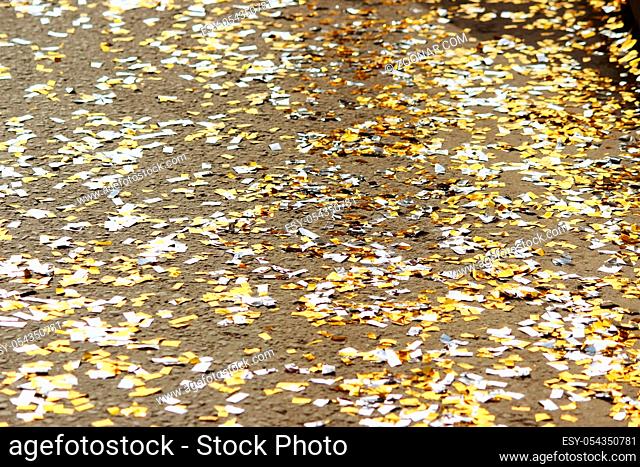 festival background with gold and silver sequins that lie on the pavement and the road and bokeh