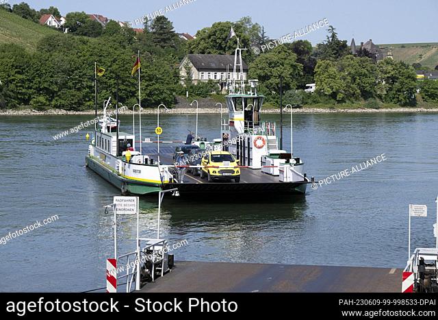 PRODUCTION - 31 May 2023, Hesse, Trebur: Thomas Mörgenthaler steers the Rhine ferry ""Landskrone"" across the Rhine near Nierstein to the landing stage in...