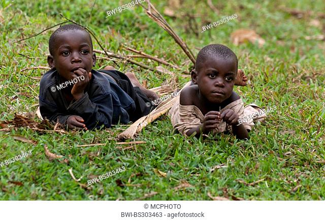 two boys lying in meadow, Uganda, Bwindi