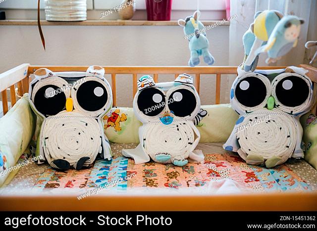 design of children bed arranged with cuddly toy, three owls as stuffed animal