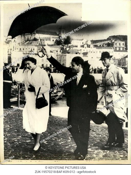 Feb. 18, 1957 - Queen And Duke In Portugal. Photo shows H.M. The Queen, protected by an umbrella, crosses the cobbled quay at Setubal, Portugal
