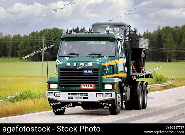 Green Sisu SR300 transports another classic lorry on truck rally by the Vintage Truck Association of Finland. Suomusjärvi, Finland. July 4, 2020