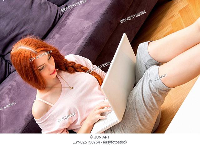 Young Woman Using Laptop In the Living Room