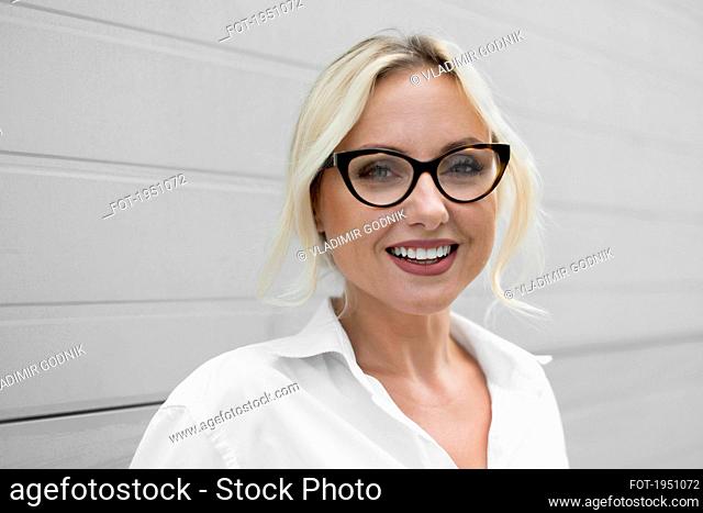 Portrait happy, beautiful businesswoman in eyeglasses