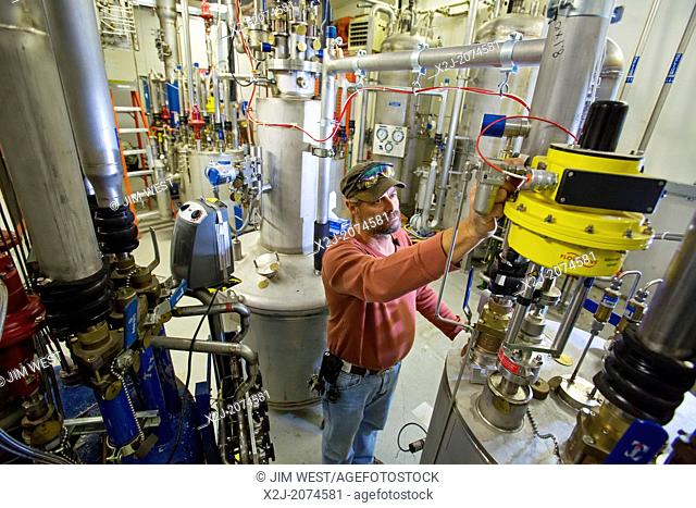 Batavia, Illinois - Cryotechnician runs equipment that provides liquid helium in the New Muon Lab at the Fermi National Accelerator Laboratory