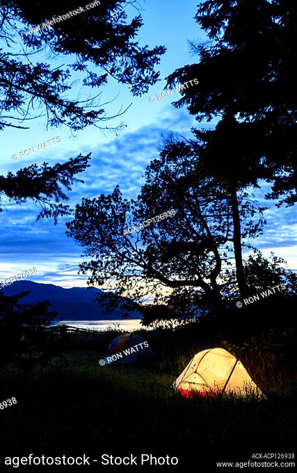 Tents at dusk at Shell Beach on Portland Island, Princess Margaret Marine Park, Gulf Islands National Park Reserve, British Columbia, Canada