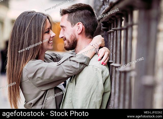 Smiling woman with arm around of boyfriend