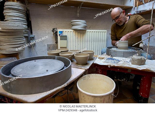 A man at a pottery wheel, working with clay, during the 13th edition of the 'Day of the crafts' (Dag van de Ambachten - Journee de l'artisan)