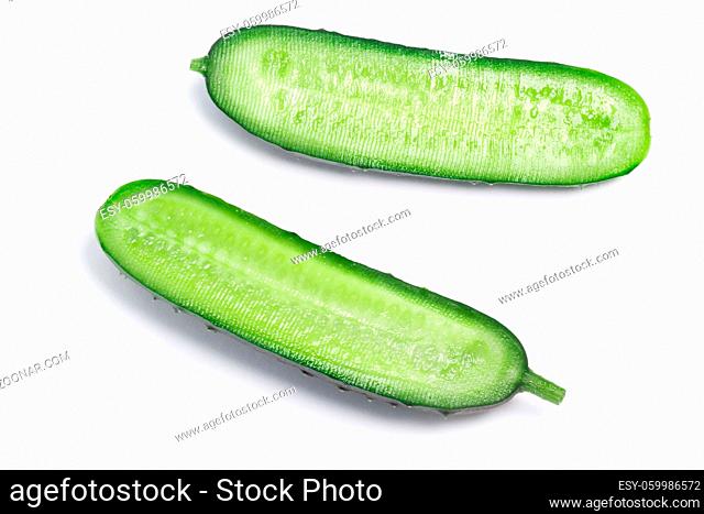 Fresh halved cucumber (Cucumis sativus), top view. Clipping paths, shadow separated
