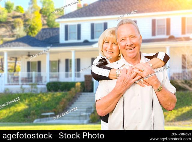 Happy Senior Couple in the Front Yard of Their House