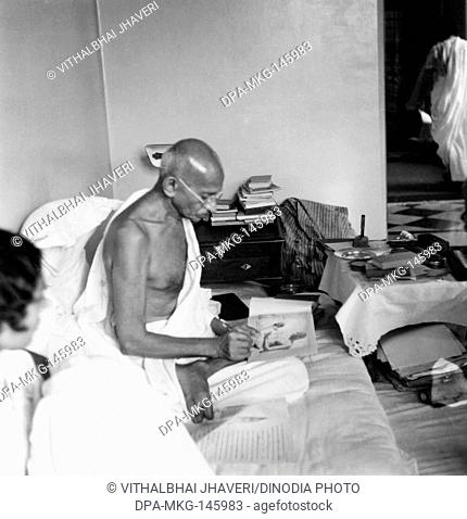 Mahatma Gandhi signing his photograph at Birla House , Mumbai , 1940 NO MR