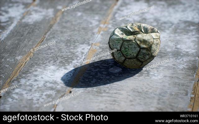 Old soccer ball the cement floor