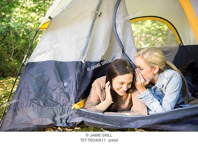 Two women lying in tent