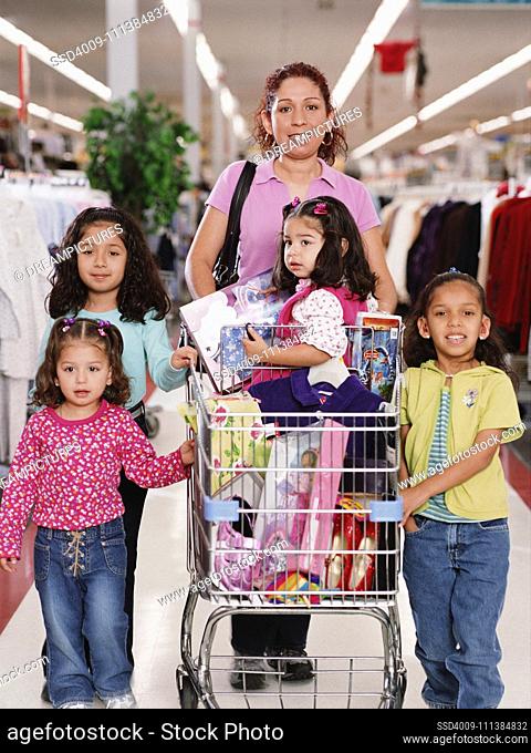 Hispanic family with shopping cart in department store