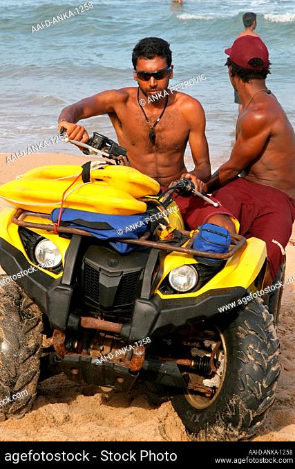 Two lifequards on quad bike buggy on beach, Umdloti, North Coast of KwaZulu-Natal, South Africa