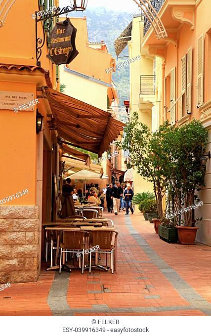 MONACO, MONTE-CARLO - MAY 15: Narrow street with old houses and sidewalk cafe at May 15, 2013 in Monaco, Monte Carlo