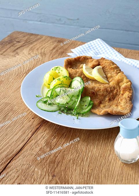 Wiener Schnitzel (breaded veal escalope from Vienna) with potatoes and cucumber salad