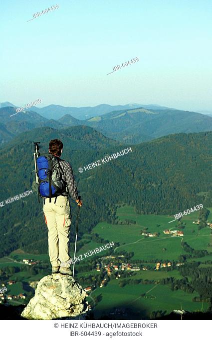 Man standing on a rock looking into the valley, Breitenstein Mountain, Bavarian foothills, Wendelstein Group, Upper Bavaria, Bavaria, Germany