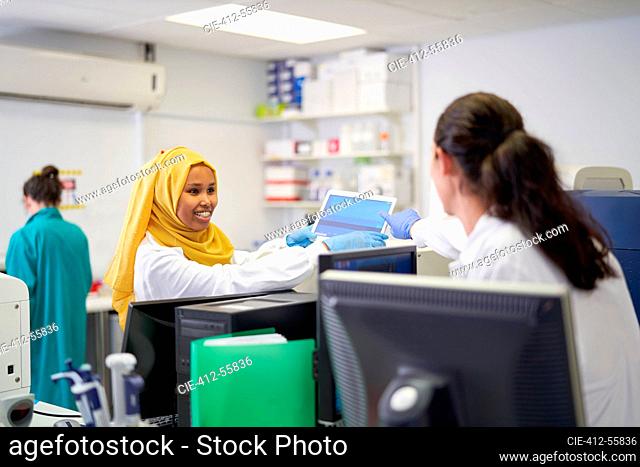 Female scientists using laptop in laboratory