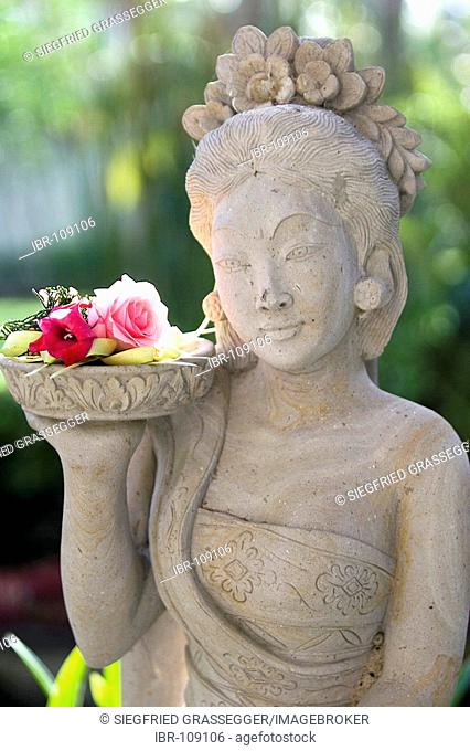 Tempelstatue with flowers in Bali Indonesia