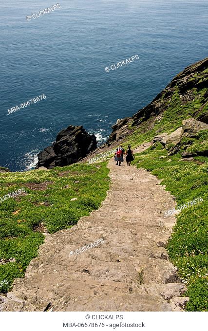 Skellig Michael (Great Skellig), Skellig islands, County Kerry, Munster province, Ireland, Europe. Tourists climbs the stairs to the monastery