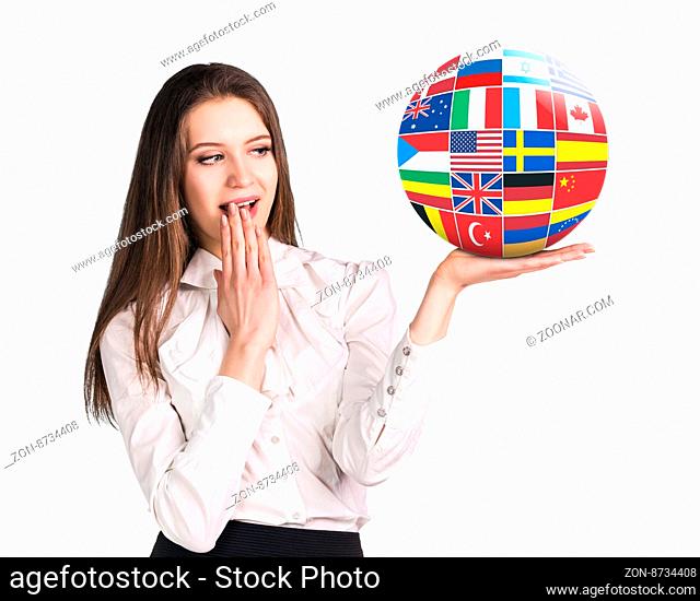 Business woman holds ball with many different countries flags isolated on white