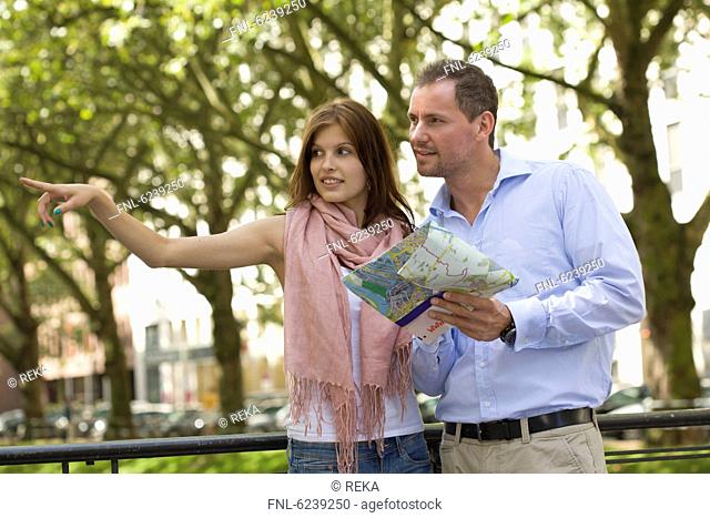 Young couple with map outdoors