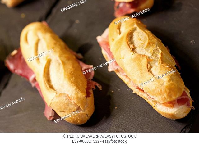 forefront of a group of Iberian ham sandwiches
