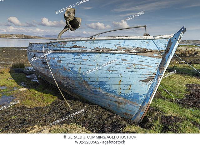 Old, derelict wooden fishing boat, left to rot on Irish coastline