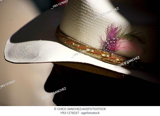 Feathers decorate a cowboy hat of a spectator at the National Charro Championship in Pachuca, Hidalgo State, Mexico. Escaramuzas are similar to US rodeos