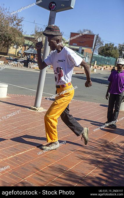 African male performing traditional Pantsula dance in Soweto Township, South Africa