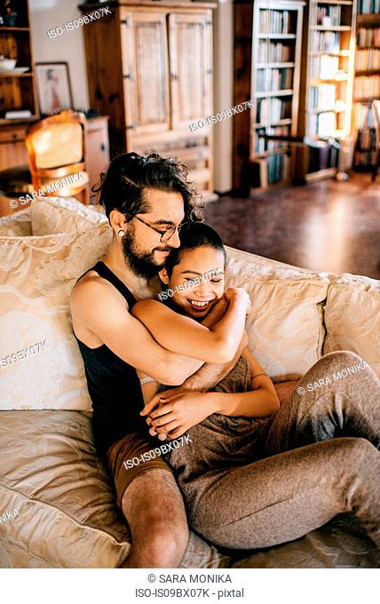 Loving couple relaxing on sofa