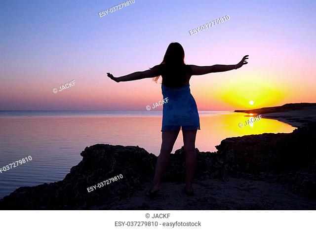 silhouette of girl at coast sea during sunrise