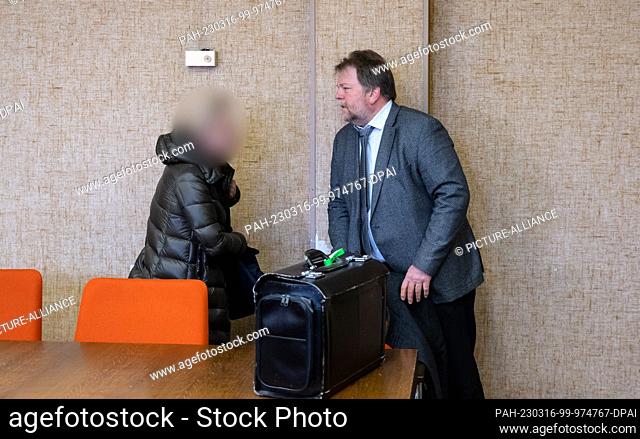 16 March 2023, Bavaria, Munich: A woman accused of negligent bodily injury stands next to her lawyer Konrad Schmalhofer in the courtroom