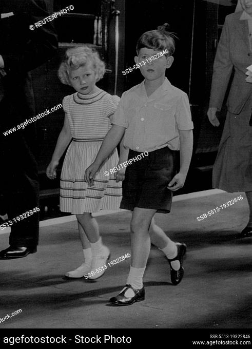 Just To Children Going On Holiday -- In simple holiday dress, Prince Charles and his sister, Princess Anne, walk ***** the train on arrival at Portsmouth to-day...