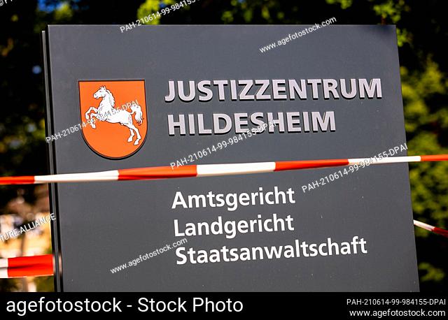14 June 2021, Lower Saxony, Hildesheim: The lettering ""Justizzentrum Hildesheim - Amtsgericht - Landgericht - Staatsanwaltschaft"" can be read in front of the...
