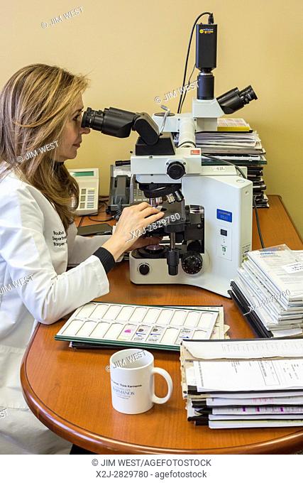 Detroit, Michigan - Dr. Rouba Ali, a pathologist at the Detroit Medical Center, examines cells under a microscope for evidence of cancer. Dr