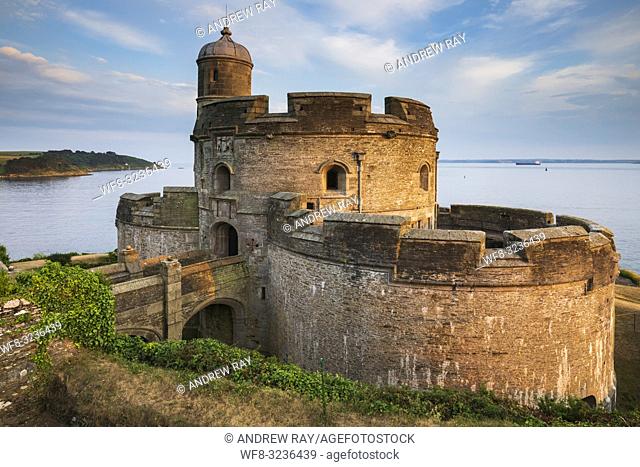 St Mawes Castle on Cornwall's Roseland Peninsula illuminated by late evening sunlight in late June with the lighthouse on St Anthony Head in the distance
