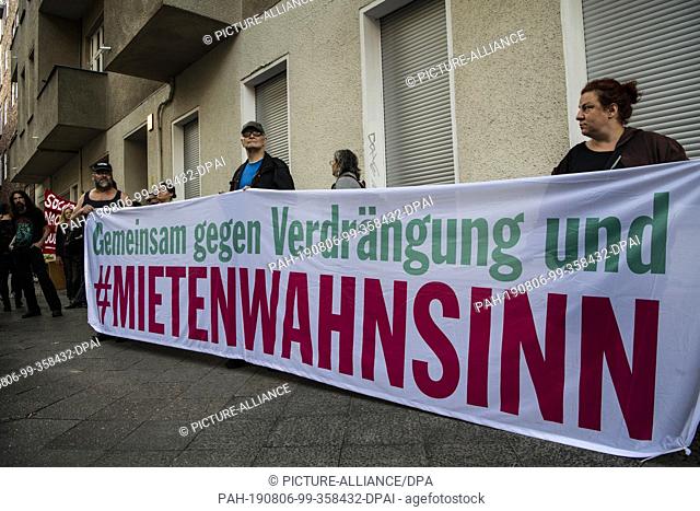 06 August 2019, Berlin: Participants in a protest against the eviction of an apartment on Dublin Street in Wedding are standing with a banner in front of the...