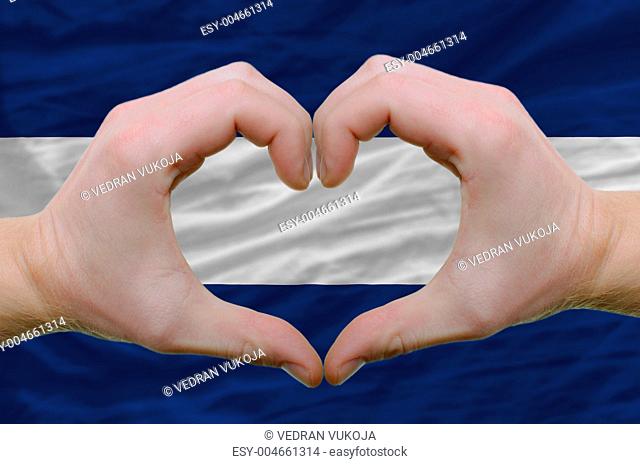 Heart and love gesture showed by hands over flag of nicaragua ba